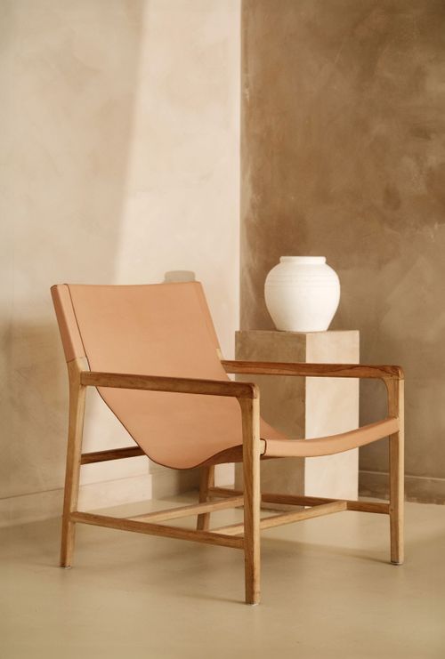 Free A cozy minimalist room with an armchair and white vase in neutral tones. Stock Photo