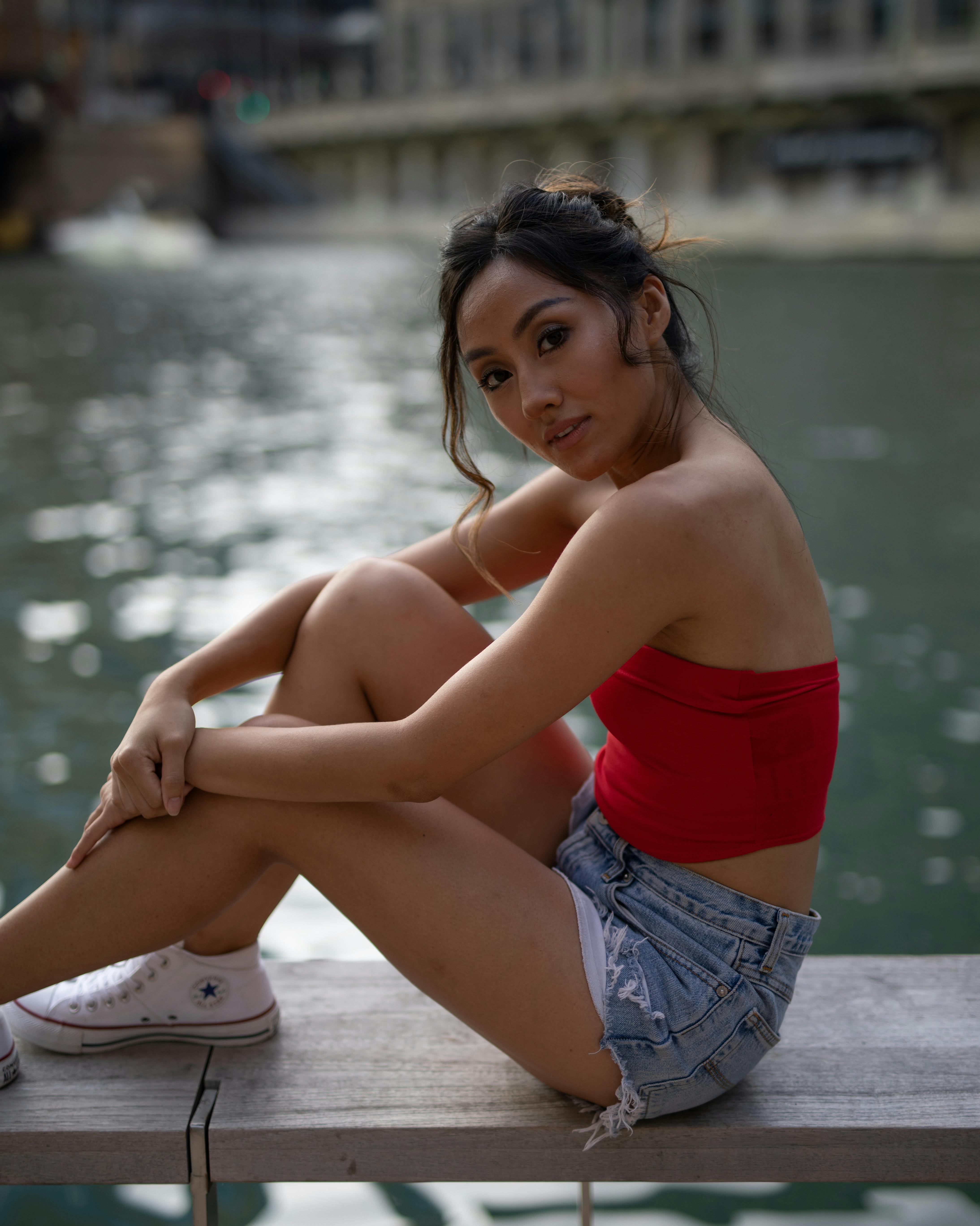 Women Wearing Red Tube And Blue Denim Shorts C · Free Stock Photo