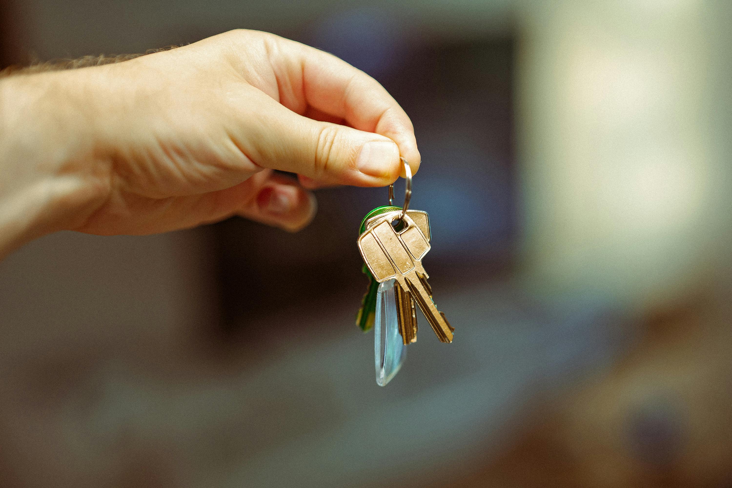 hand holding keys to a new house real estate residential