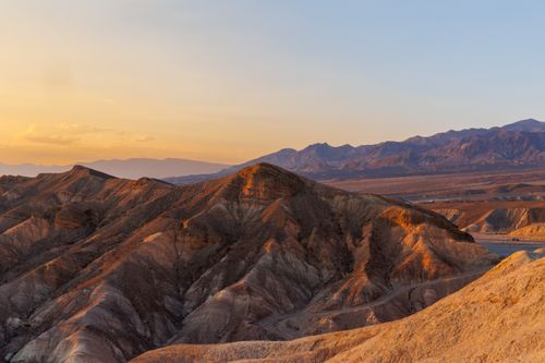 Free Experience a breathtaking golden sunset over the rugged mountains of Death Valley, CA. Stock Photo