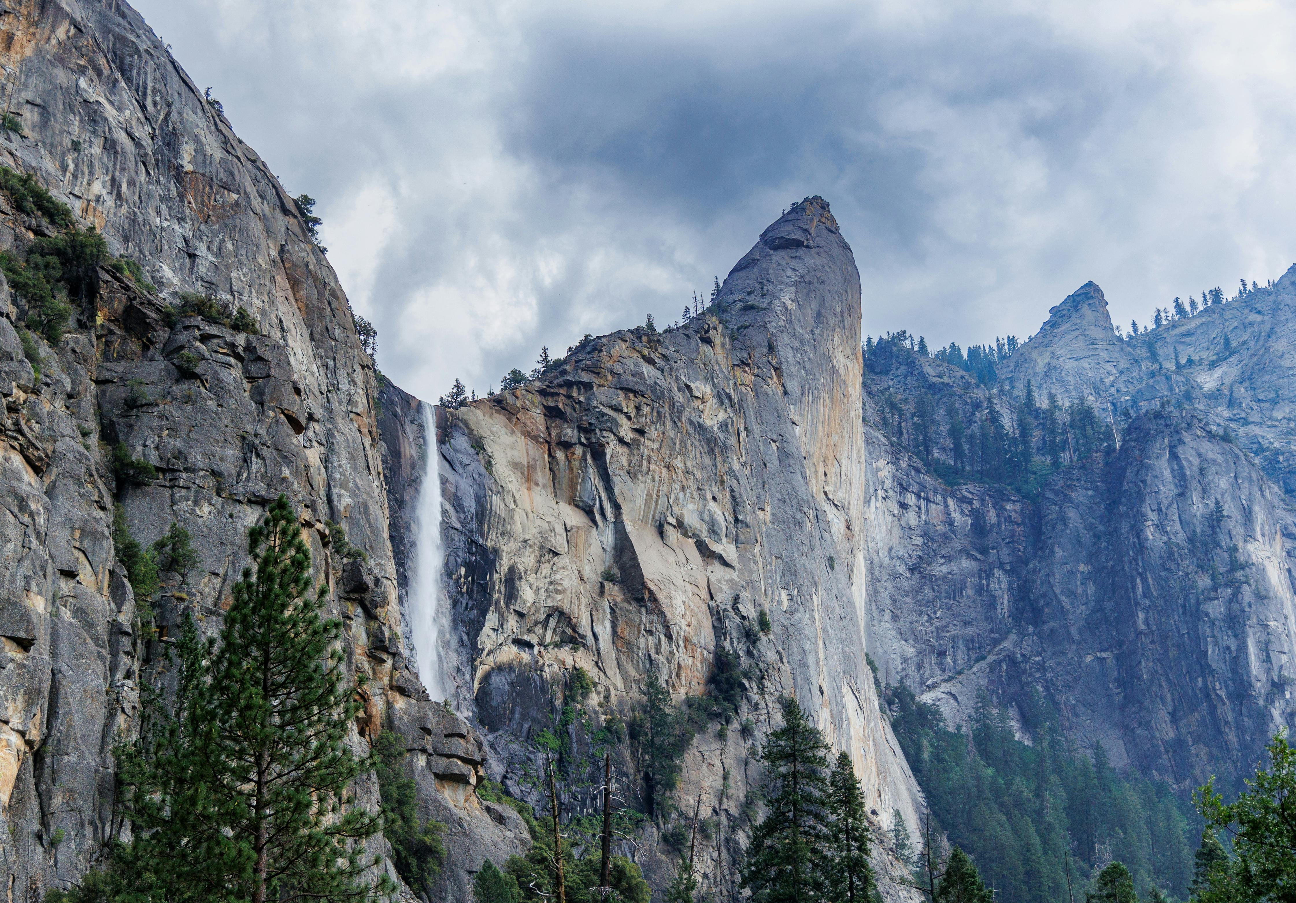 a waterfall is seen in the mountains