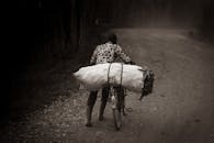 A man on a bicycle carrying a large bag
