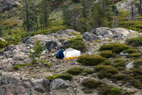 Free Explore the tranquility of a mountain camping adventure with a tent in the wilderness. Stock Photo
