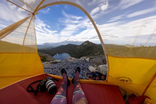 Free Wide-angle view of a mountain from a tent, showcasing outdoor adventure and serene landscape. Stock Photo