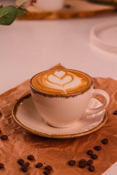 A close-up of a cappuccino with heart-shaped latte art, perfect for coffee lovers.