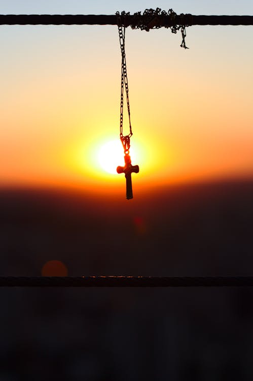 Free Silhouette Photography of Figaro Chain Necklace With Cross Pendant Stock Photo