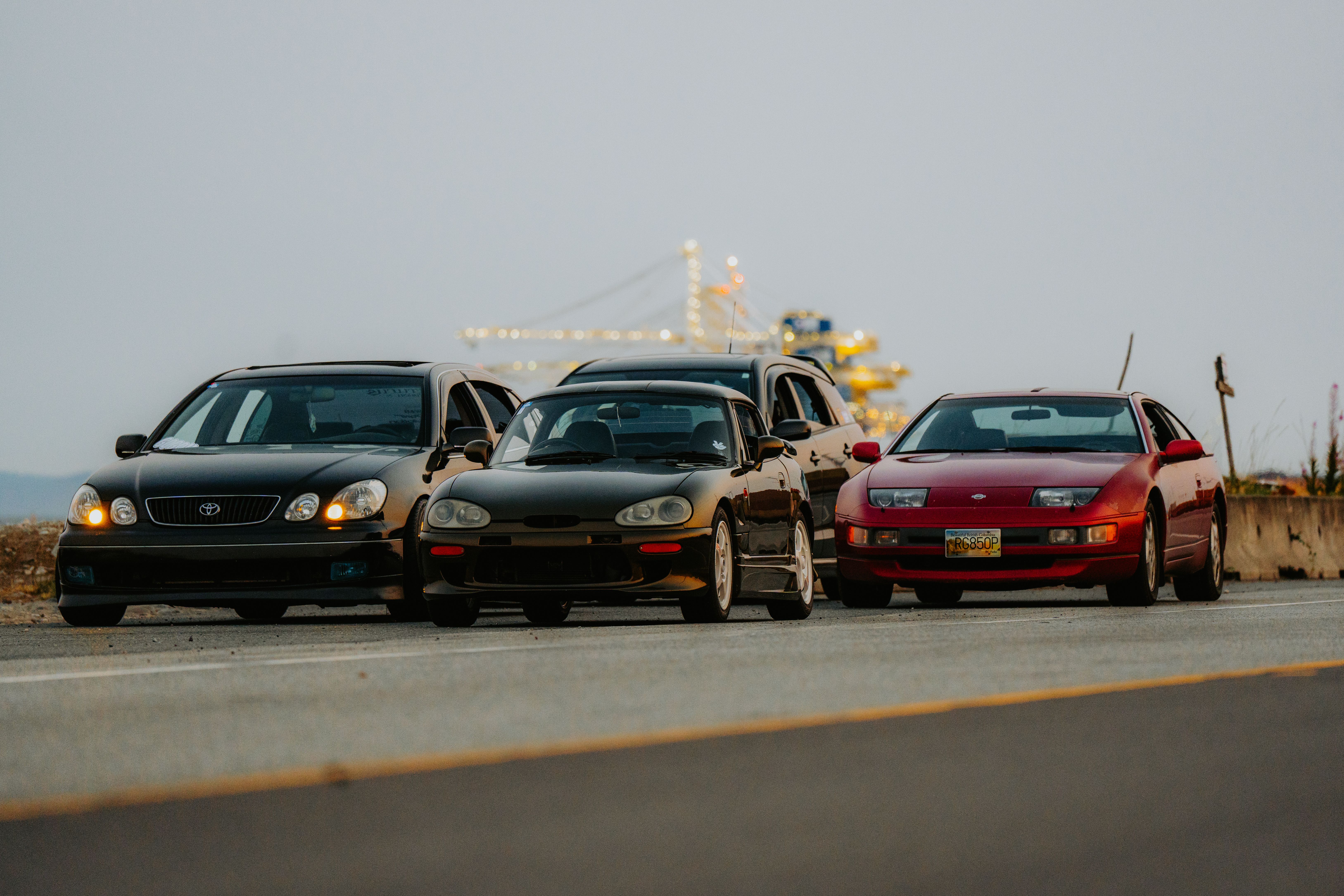 Three cars are parked on the side of the road · Free Stock Photo