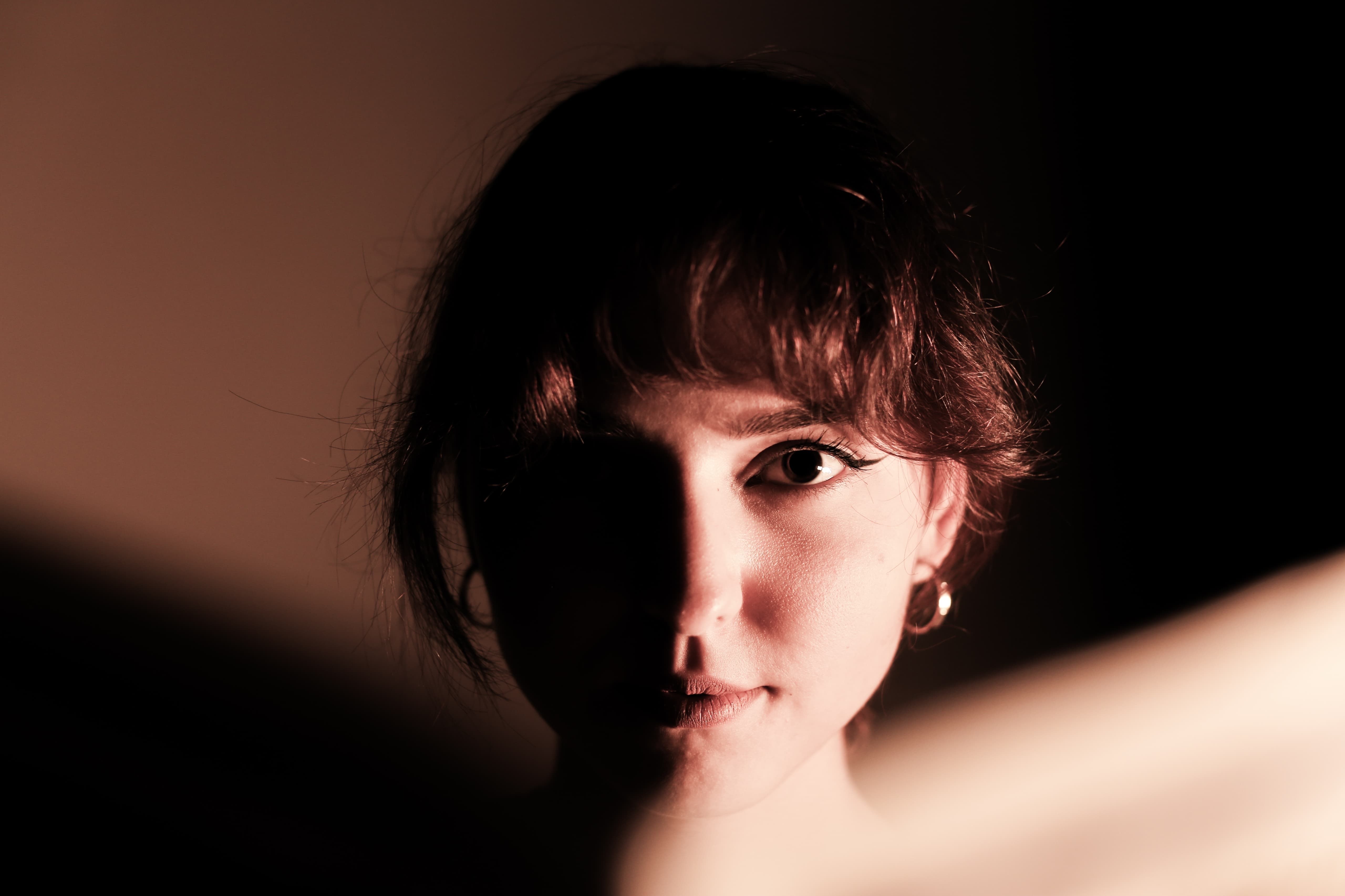 Artistic portrait of a woman with dramatic lighting and shadow play.. artistic, portrait, woman