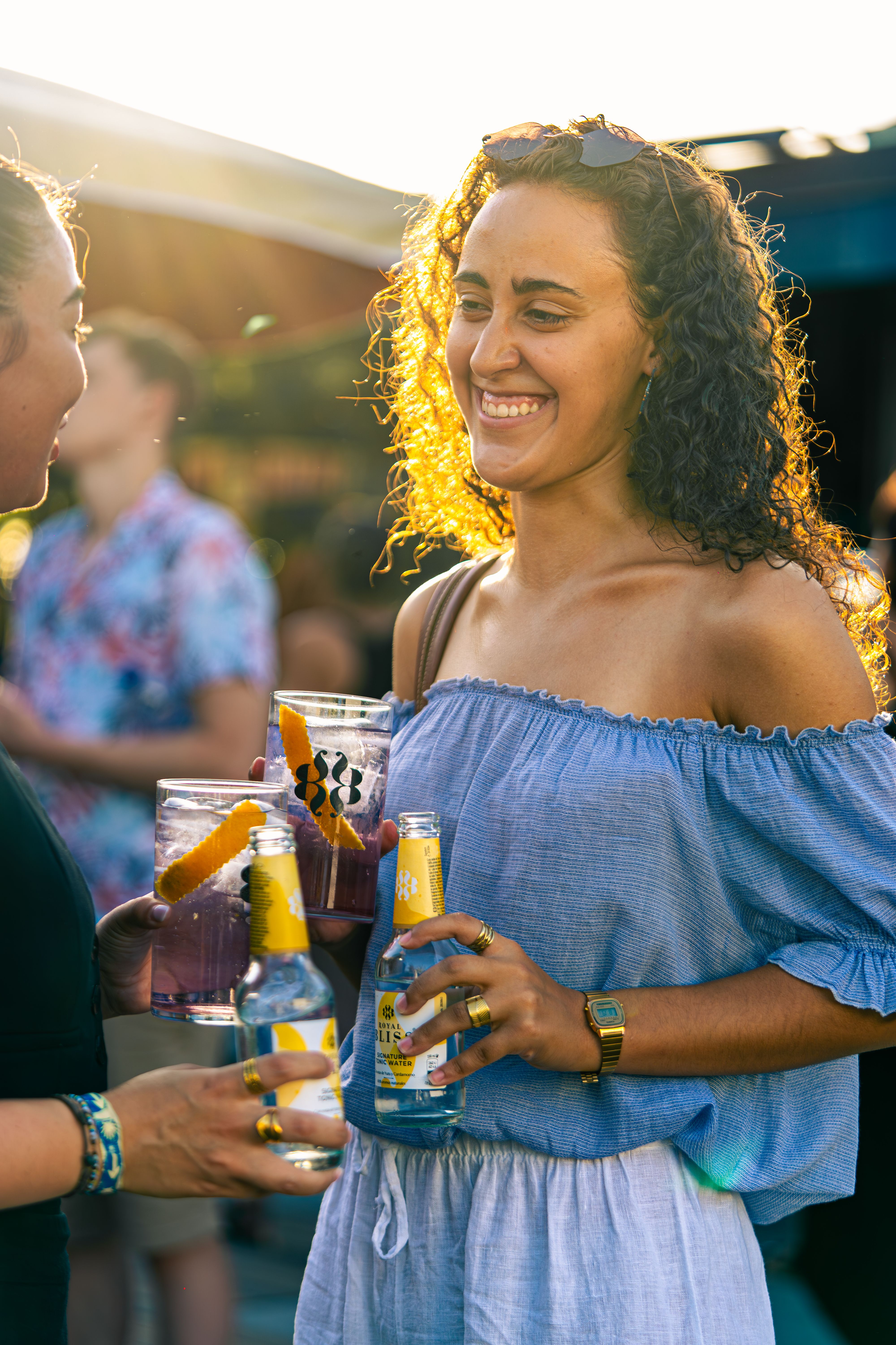 A lively party scene with friends enjoying sunny summer celebration outdoors.
