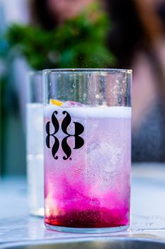 Vibrant pink cocktail in a clear glass, perfect for summer refreshment.