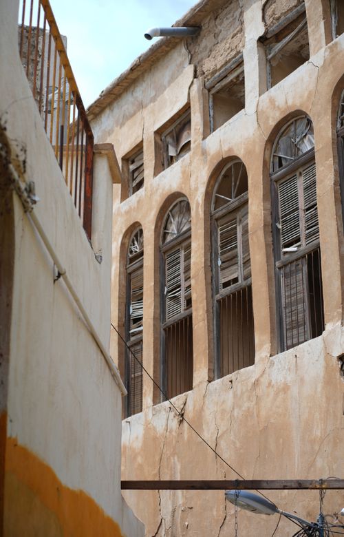 Free Historic building facade with arched windows and deteriorating walls, capturing urban decay and architectural detail. Stock Photo