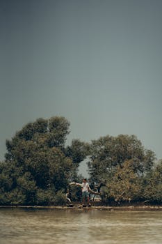 A lone fisherman stands by the mangroves in Marsa Alam, embodying serene isolation.