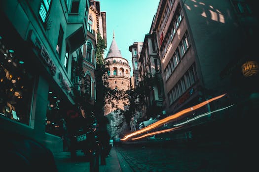 Long exposure shot of Galata Tower in Istanbul with vibrant light trails and urban architecture.