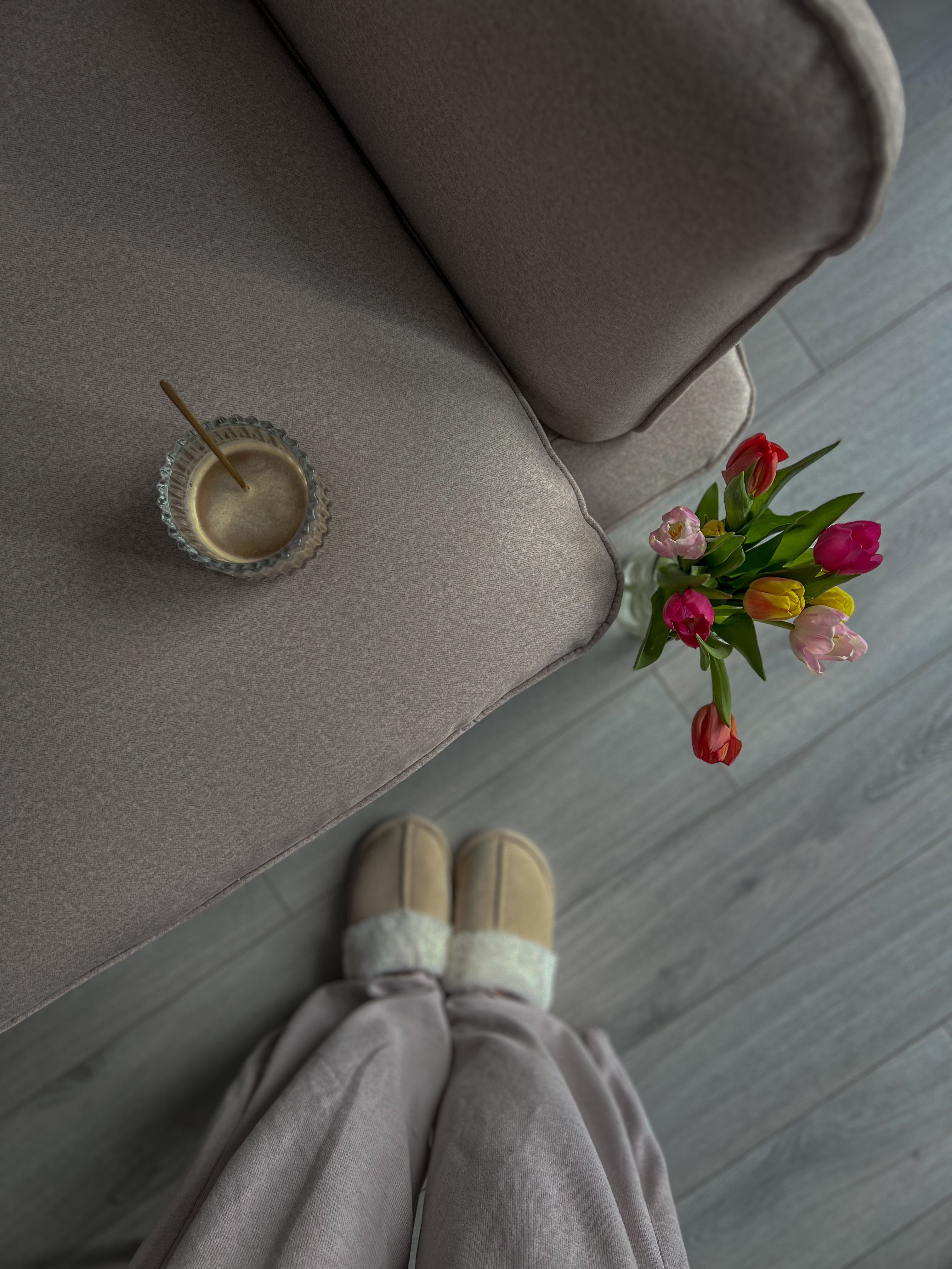 A person's feet are on a couch with a cup of coffee · Free Stock Photo