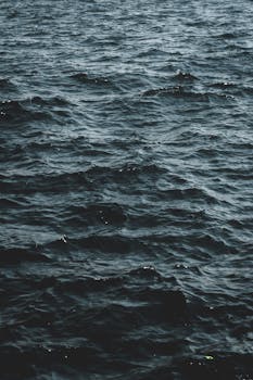 Capture of tranquil ocean waves in a cool dark tone perfect for peaceful backdrops.