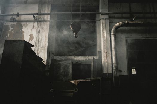 Spooky abandoned industrial interior with fog and decayed structures in Kayseri, Türkiye.
