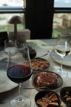 Sophisticated indoor dining scene with red and white wine, perfect for luxury culinary themes.