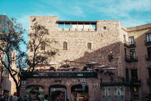 Free Sunlit historic stone building in Barcelona's urban plaza captured during a bright day. Stock Photo