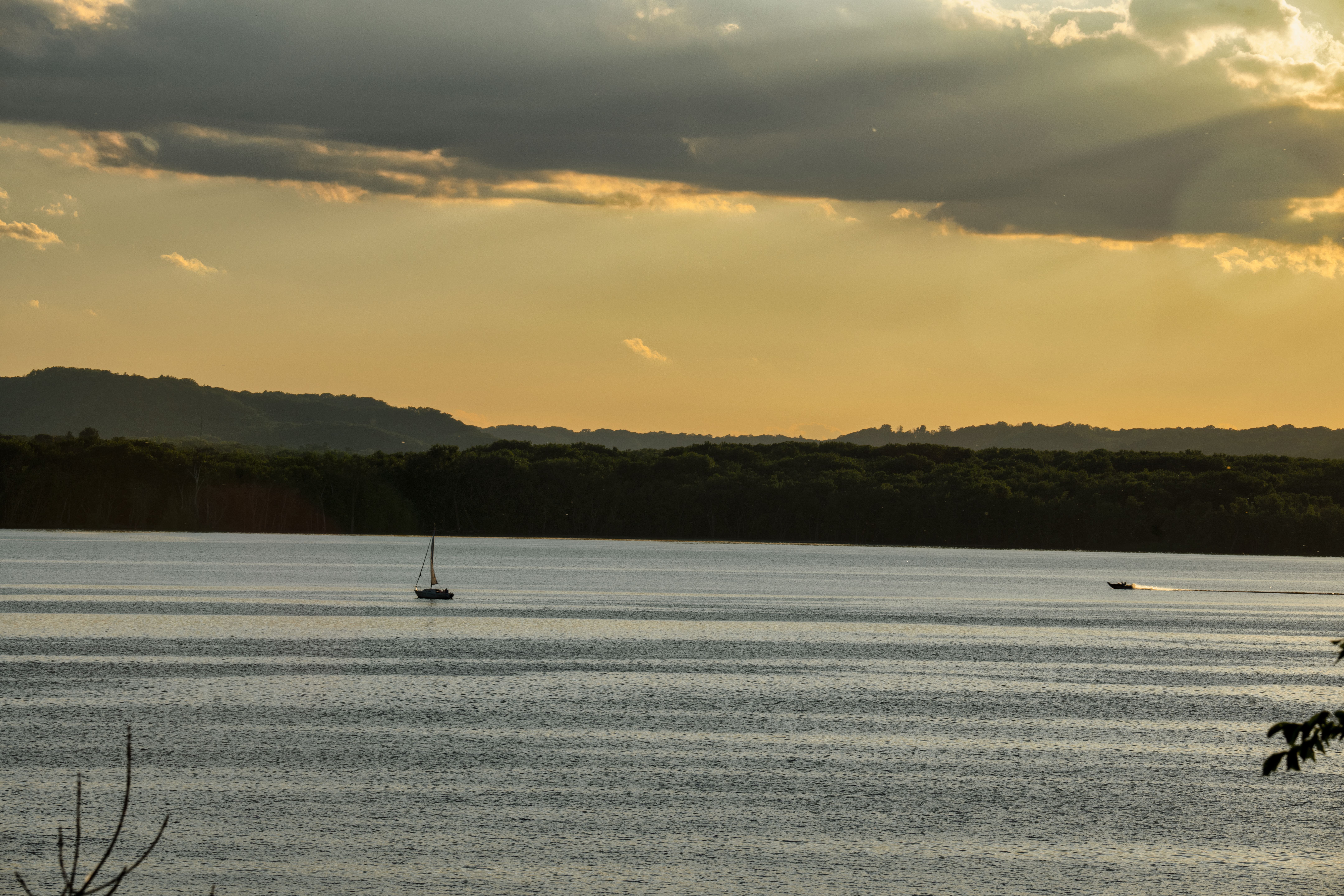 Peaceful sunset with boats on Lake Pepin in Stockholm, WI, reflecting golden hues.
