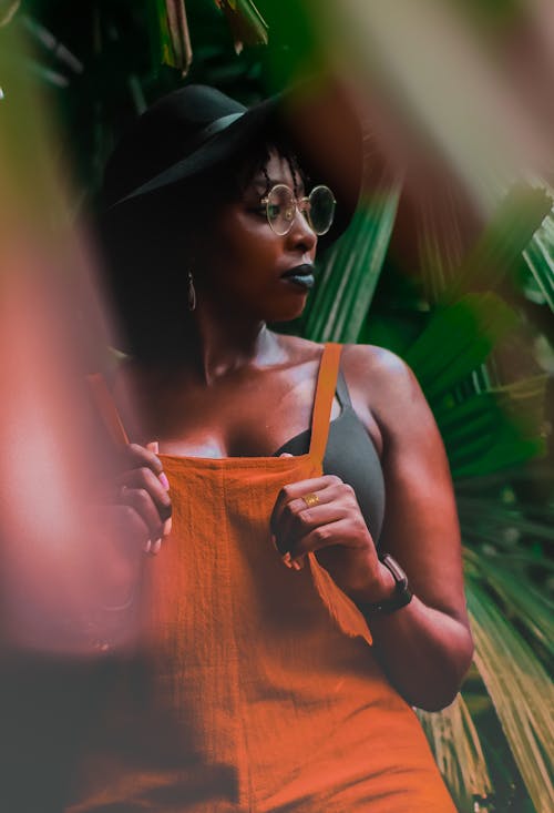 Free Selective Focus Photo of Woman in Orange Outfit Posing While Looking Away Stock Photo