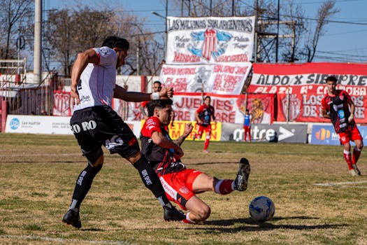 Dynamic soccer match action captured as players compete for the ball in a lively stadium.