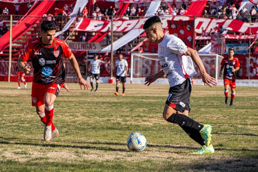 Dynamic soccer action during an intense match at a vibrant stadium with players giving it their all.