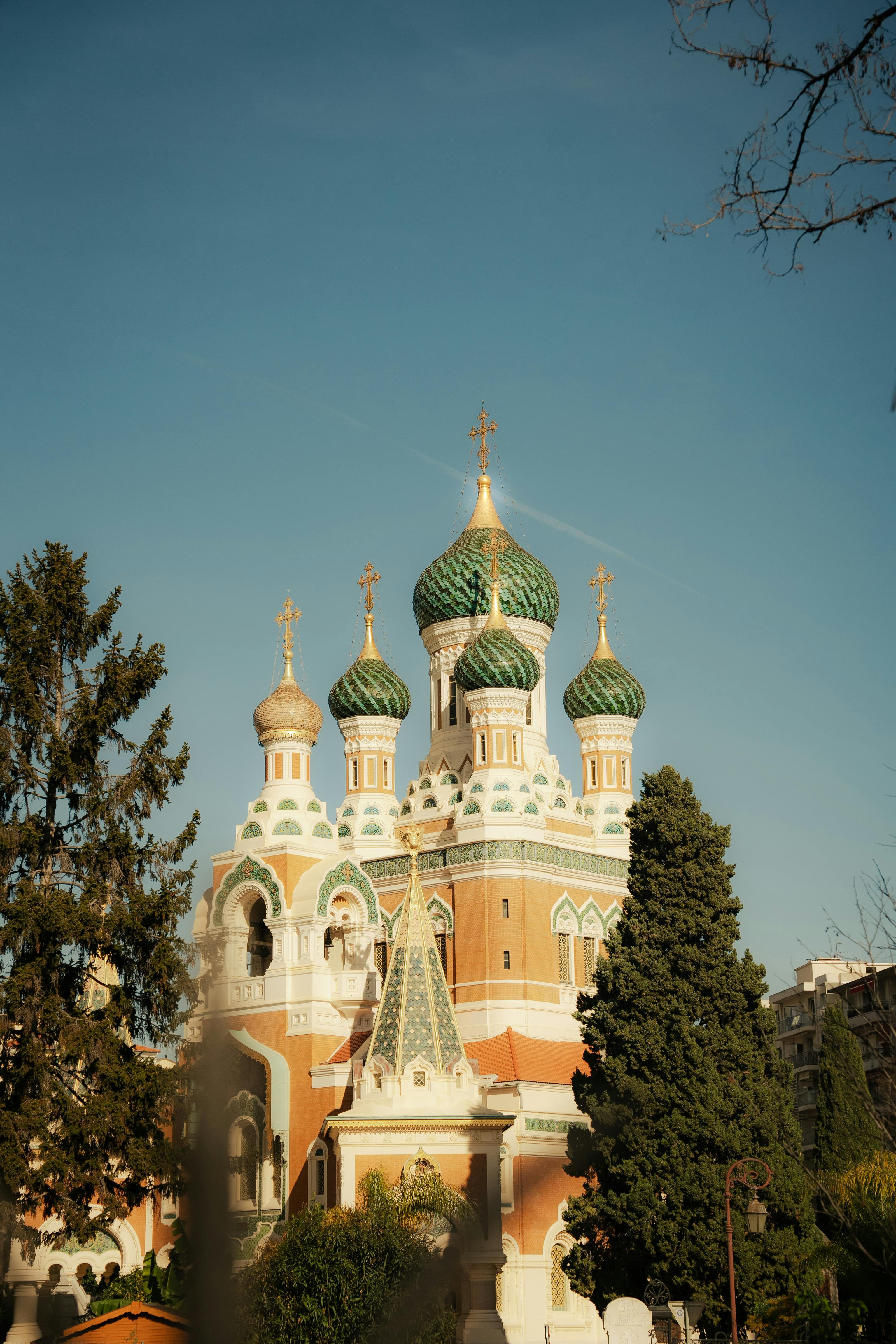 Captivating view of the Russian Orthodox Cathedral with green domes in Nice, France, under a clear sky.