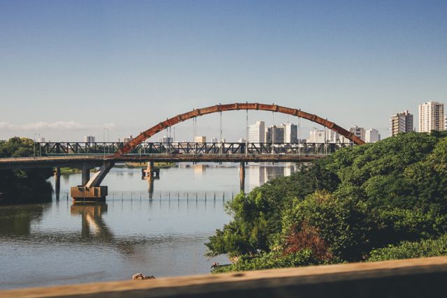 Scenic bridge view in Campos dos Goytacazes, Brazil with city skyline reflections.