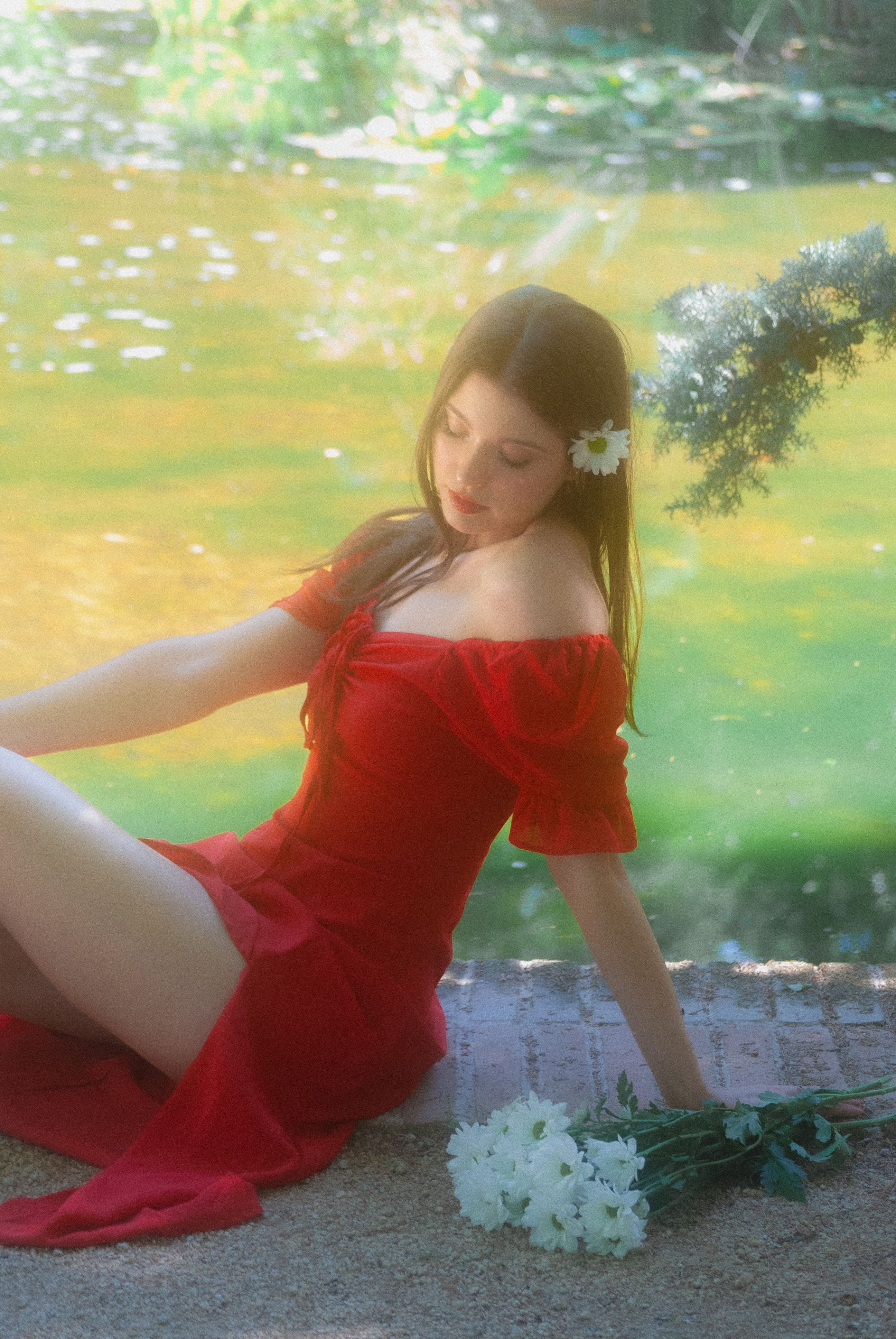 A woman in a red dress sitting on the ground · Free Stock Photo