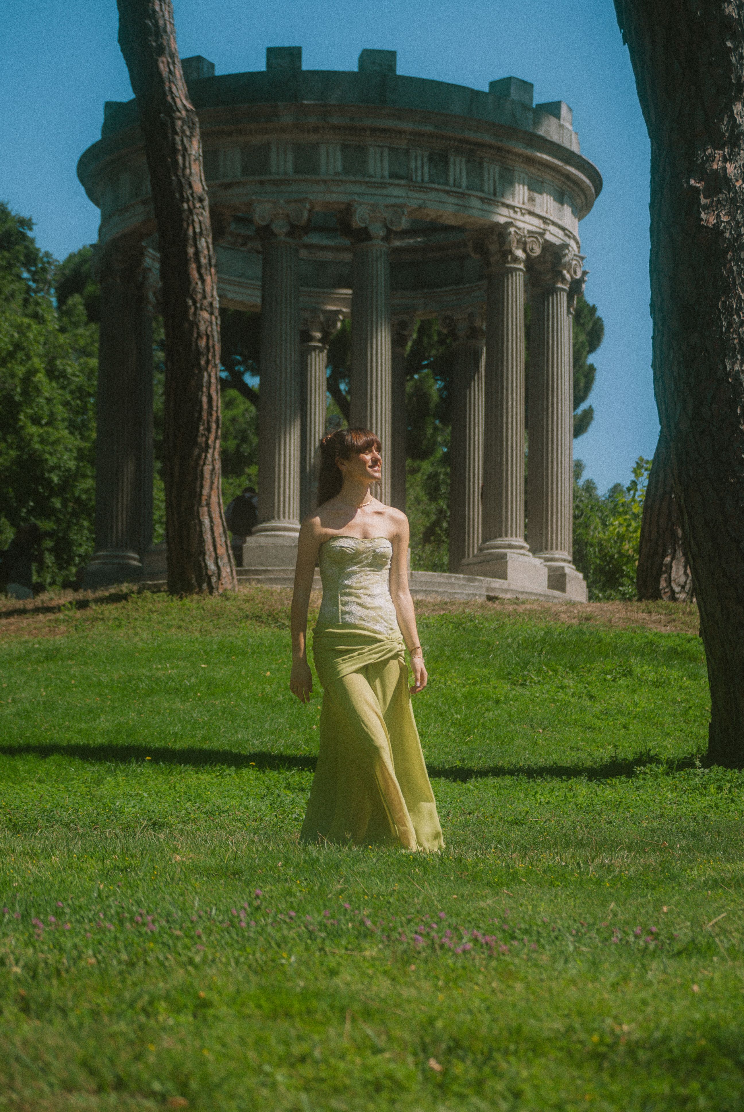 A woman in a long yellow dress standing in the grass · Free Stock Photo