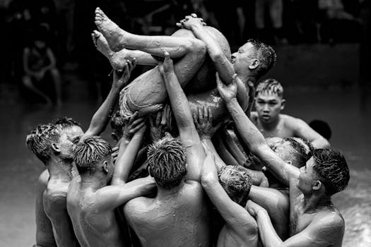 Men participating in a mud festival in Bắc Giang, Vietnam showcasing traditional culture.