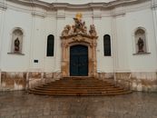 Captivating baroque facade of a historical church in Bratislava, Slovakia, showcasing intricate sculptures and architecture.