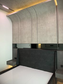 Contemporary minimalist bedroom with sleek furniture and elegant design elements.