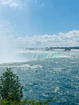Stunning vista of Niagara Falls with a clear blue sky and vibrant waters, captured in Toronto, ON, Canada.