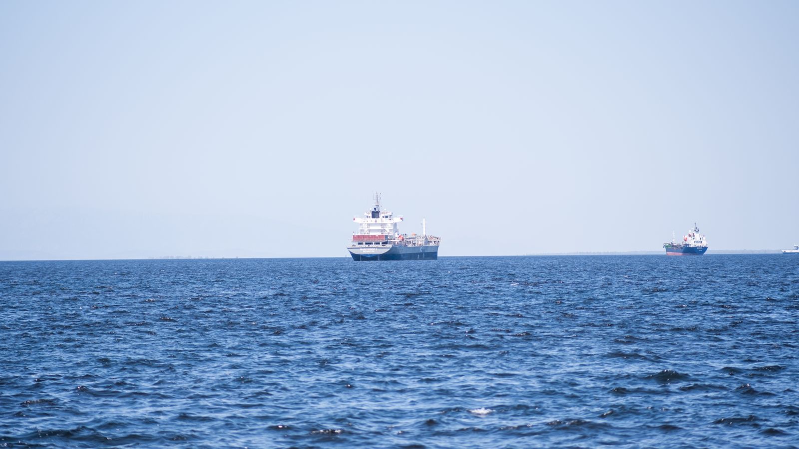 Two ships are in the ocean near a large body of water, Somalia