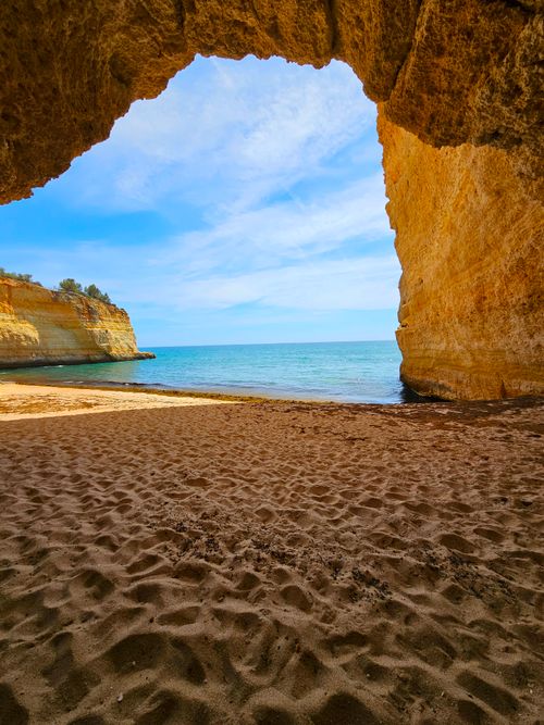 Free Coastal cave in Algarve, Portugal revealing a stunning view of the sea and cliffs. Stock Photo