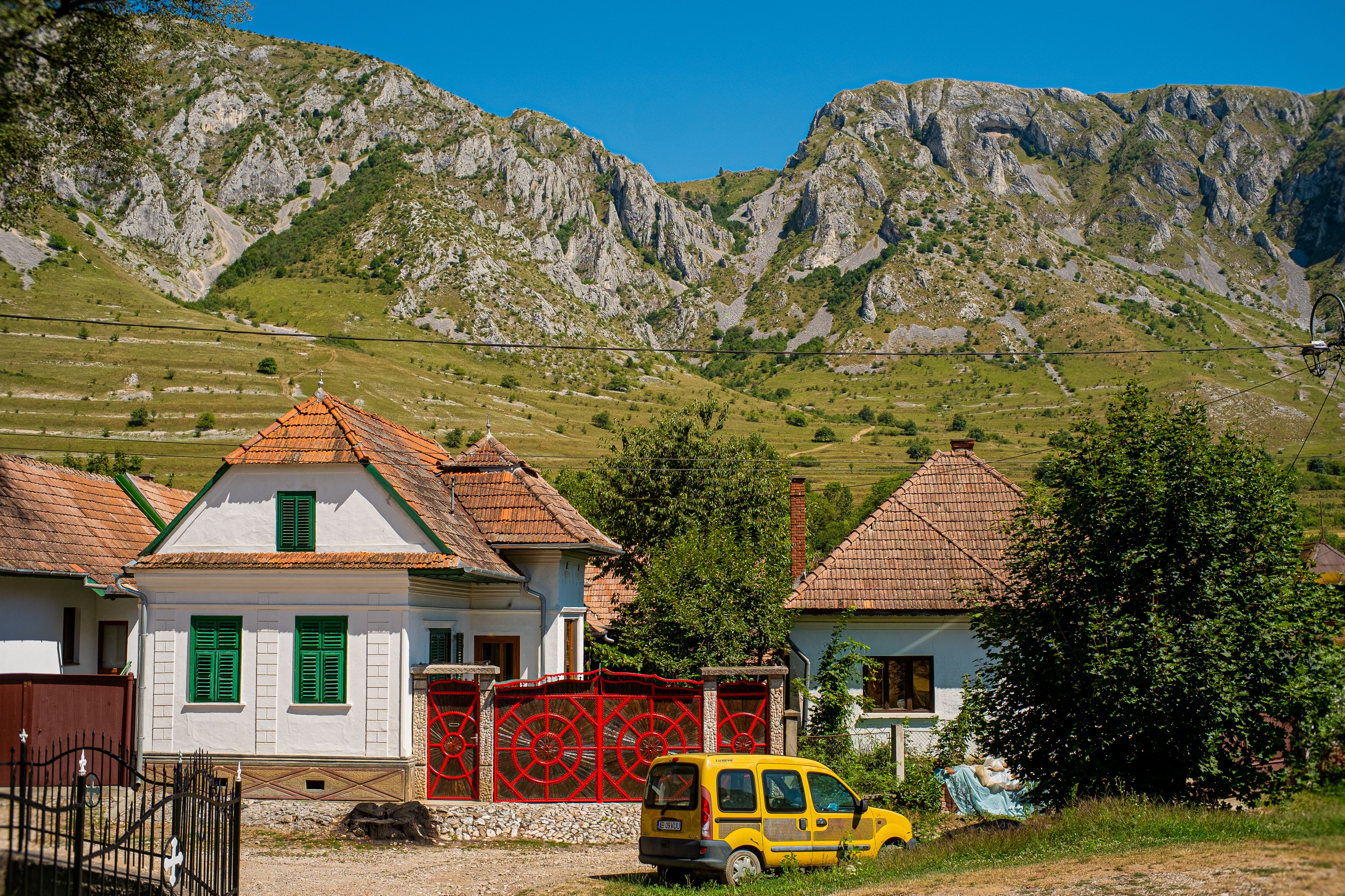 Picturesque village scene with traditional houses nestled against a stunning mountain backdrop.
