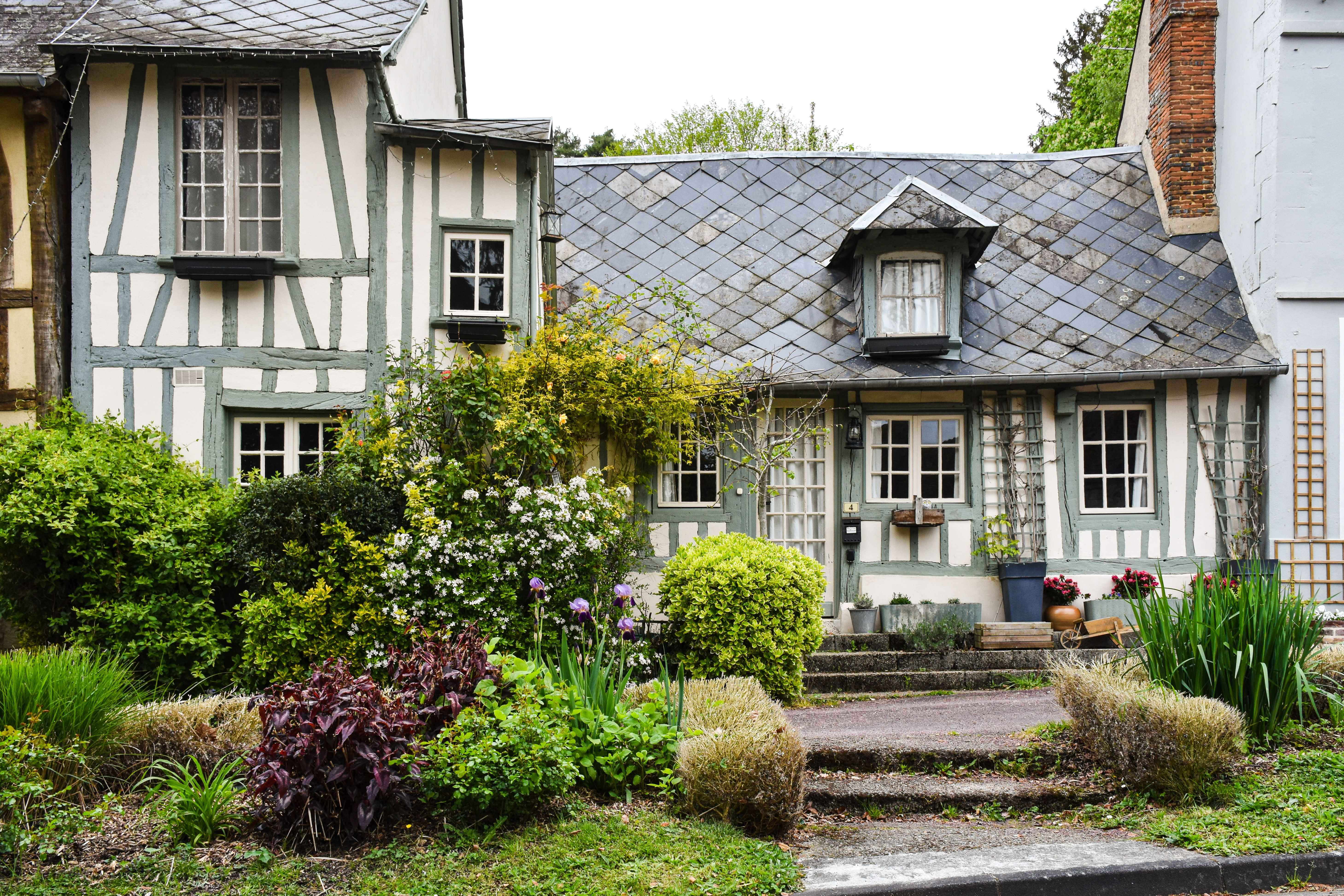 Quaint half-timbered house in Normandy surrounded by a vibrant garden. — photo by AXP Photography on Pexels