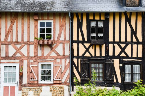 Free Historic half-timbered houses with wooden shutters in Normandy, France. Stock Photo