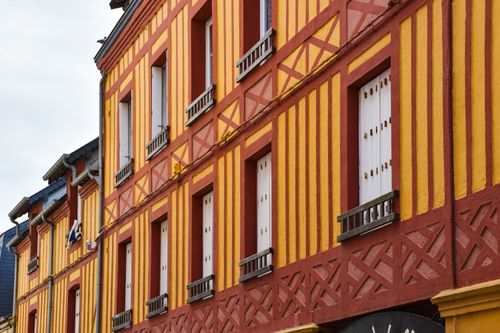 Free Vibrant facade of traditional half-timbered house in Normandy, showcasing artistic architecture. Stock Photo