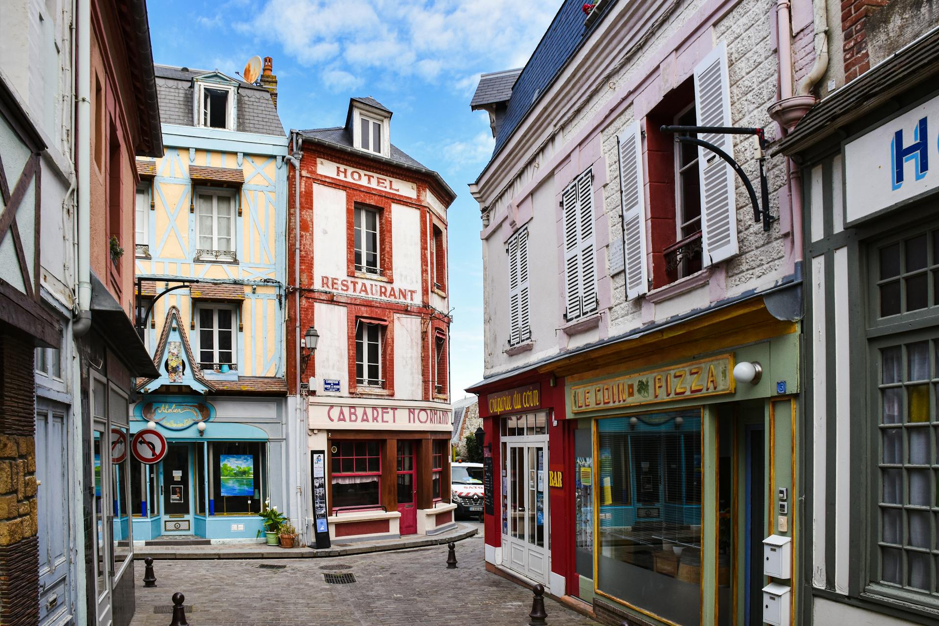 Charming street in Normandy with colorful buildings and classic European architecture.
