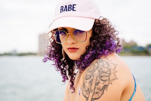 Free Trendy woman with sunglasses and tattoo enjoying a day by the Chicago lakefront. Stock Photo