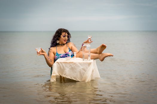 Caucasian woman in swimsuit with drinks at a table in lake, embodies summer relaxation in Chicago.
