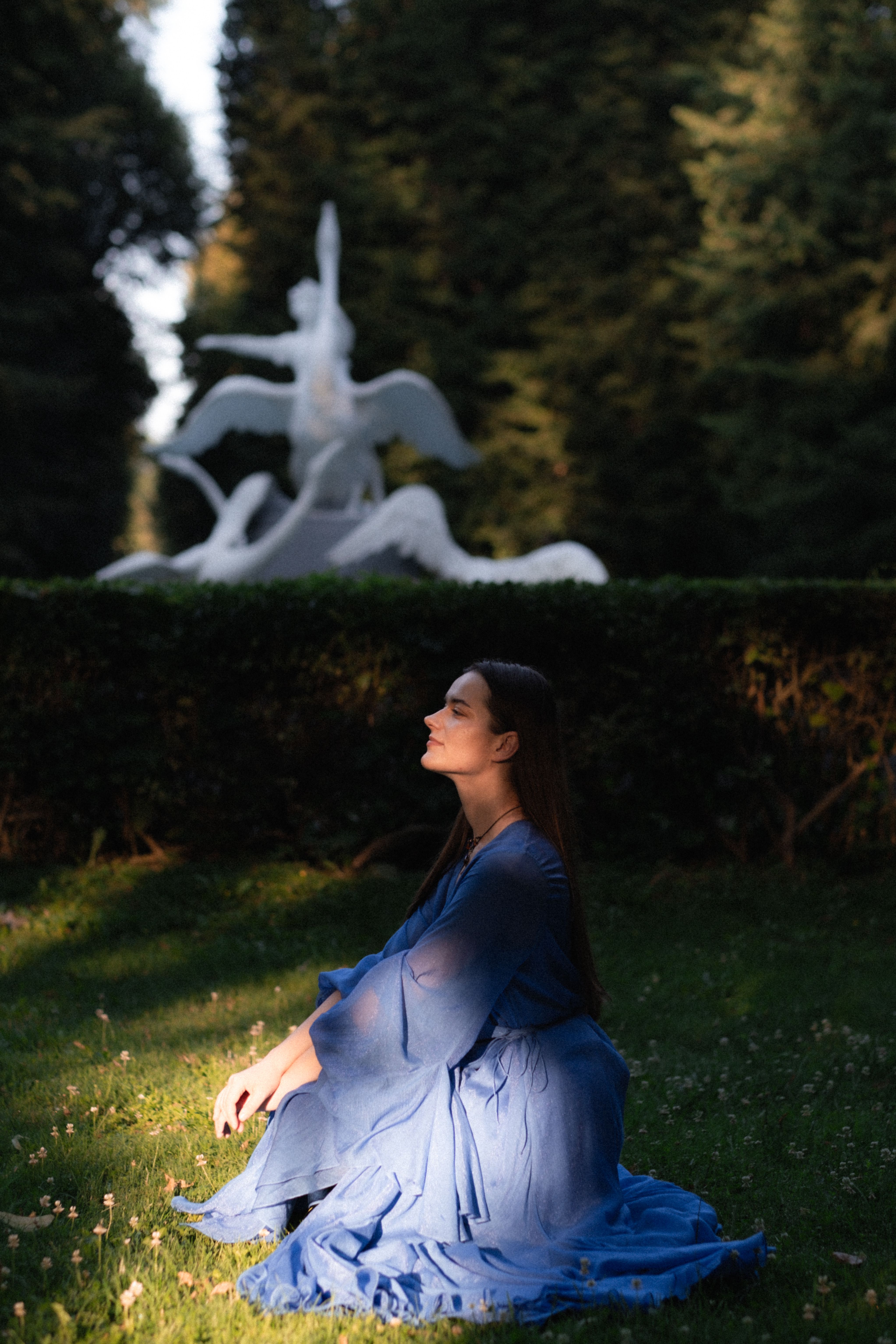 A woman in a blue dress sitting on the grass · Free Stock Photo