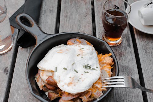 Free Cooked Eggs and Meat on Cast-iron Pan Stock Photo