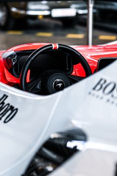 Detailed view of a classic racing car's steering wheel, showcasing design and craftsmanship.