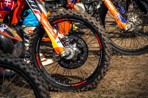 Free Detailed view of a motocross bike wheel on dirt, captured outdoors in Slovakia. Stock Photo