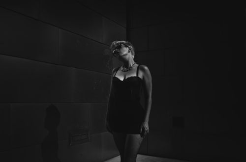Free Dramatic black and white portrait of a woman in shadows with a stylish pose. Stock Photo