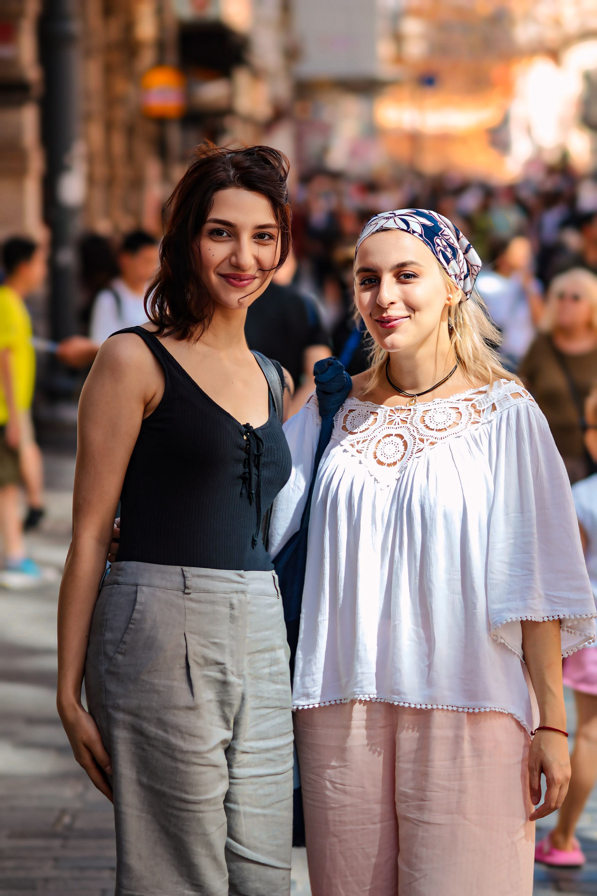 Two women standing on a street in a city · Free Stock Photo