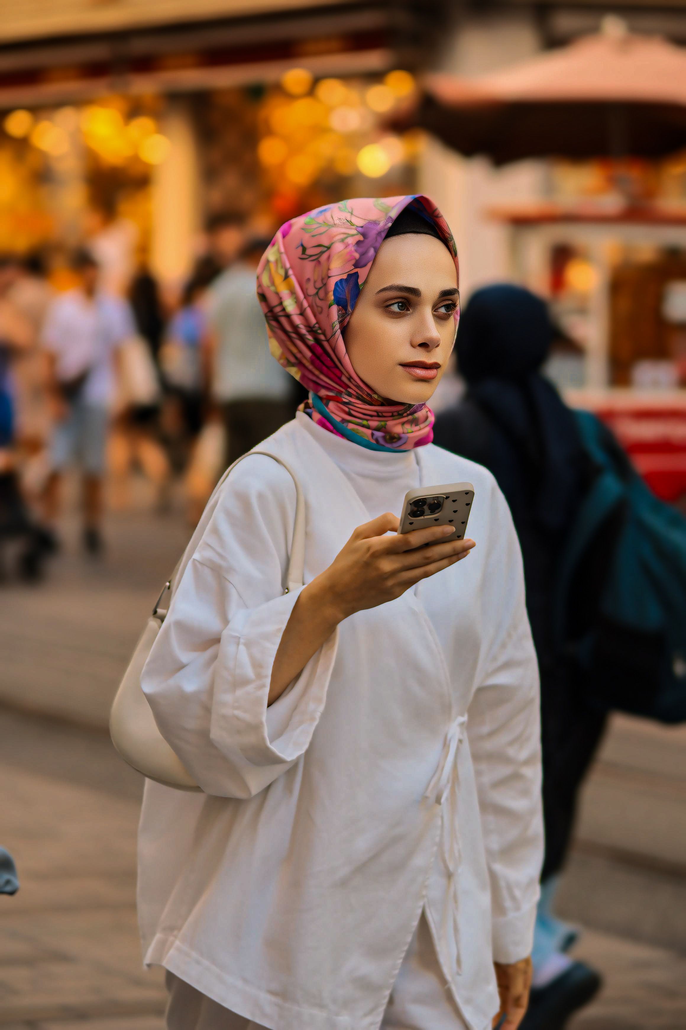 A woman in a hijab is using her cell phone · Free Stock Photo
